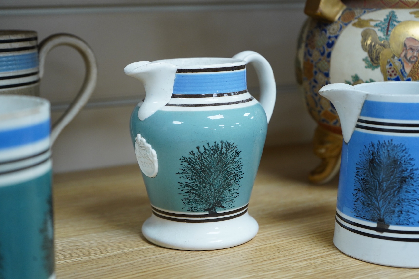 Two early 19th century Mocha ware jugs and two mugs, largest 16cm high